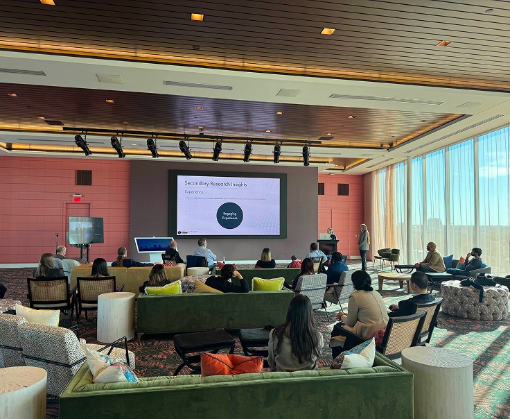 Audience seated for a presentation in a lounge space